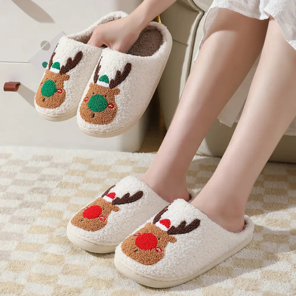 White plush reindeer plush christmas slippers with cozy faux fur featuring embroidered faces with brown antlers and green hats