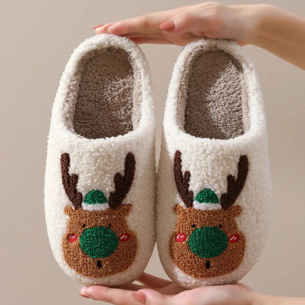 Reindeer plush christmas slippers with cozy white faux fur and embroidered reindeer faces with brown antlers and green hats