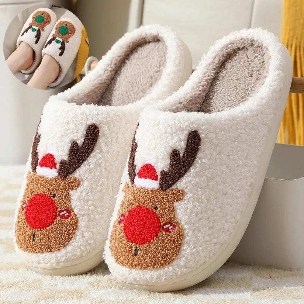 White plush reindeer slippers with embroidered faces, brown antlers, red noses, santa hats, and cozy faux fur lining