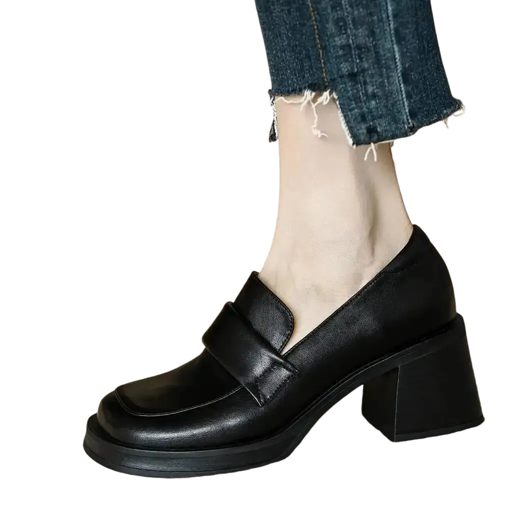 Black leather chunky heel loafers with a block heel and single strap across the toe for stylish wear
