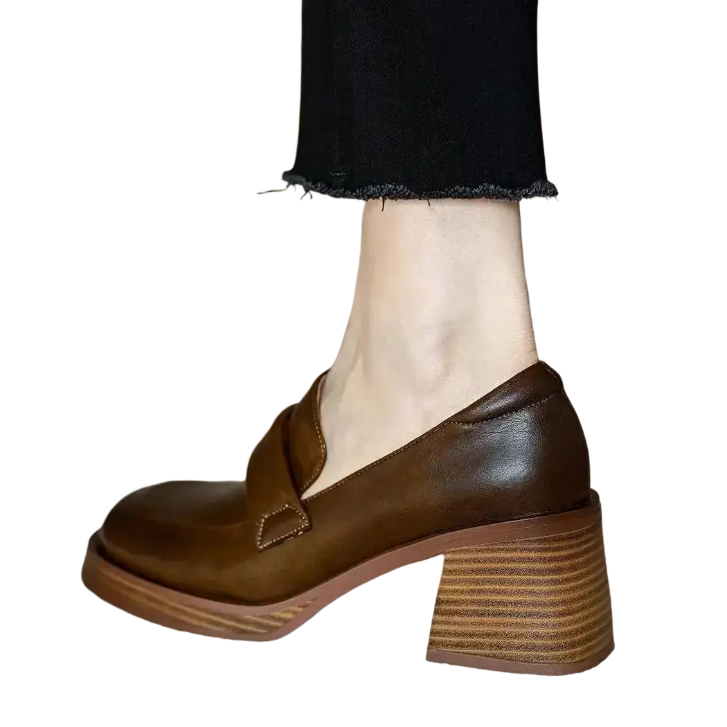 Brown leather chunky heel loafer with a stacked heel and single strap across the vamp for stylish wear