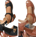 Black and tan chunky heel sandals with buckle, gold-tone metal accents, stitched detailing, chain anklet, and pigskin lining