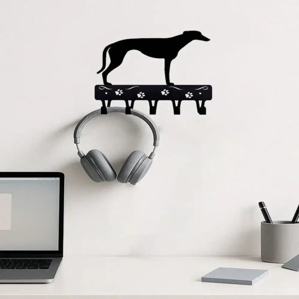 Black metal wall-mounted key rack shaped like a greyhound with paw print details for organizing keys
