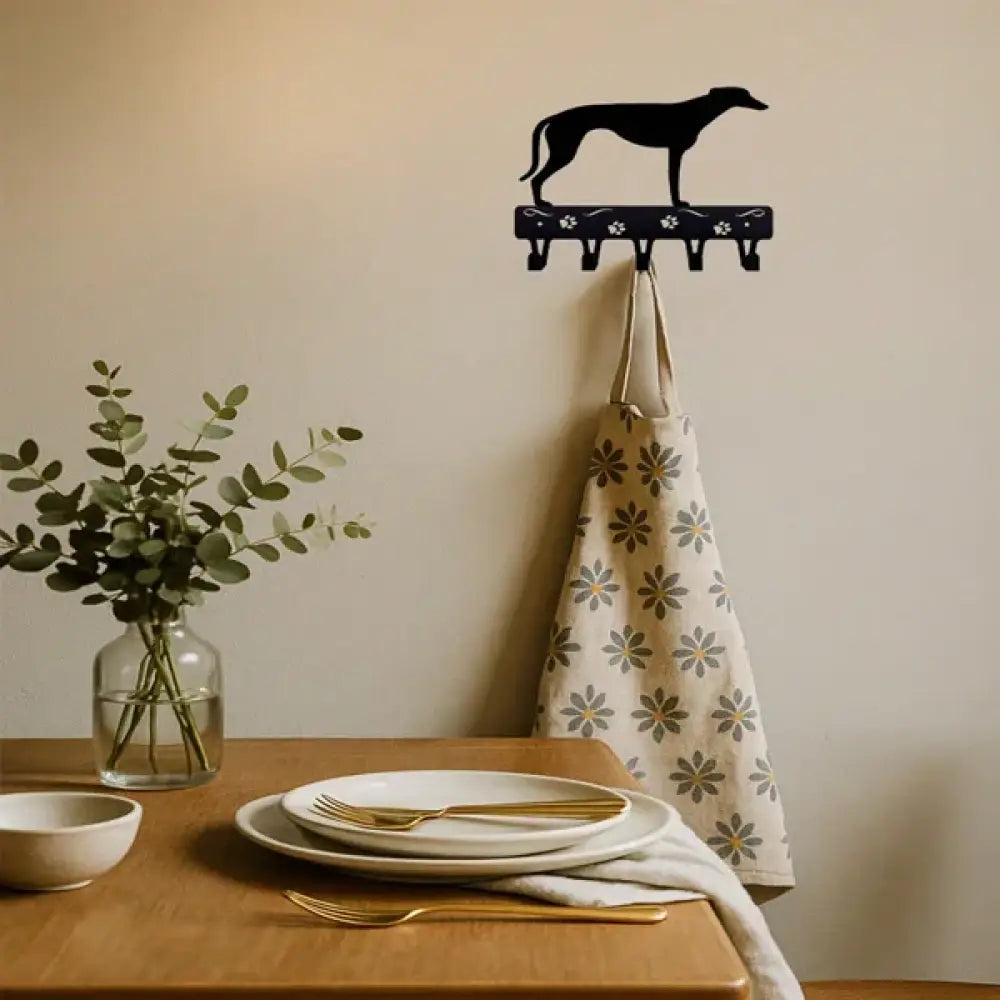 Black metal wall-mounted key rack shaped like a greyhound with paw print details for organizing keys