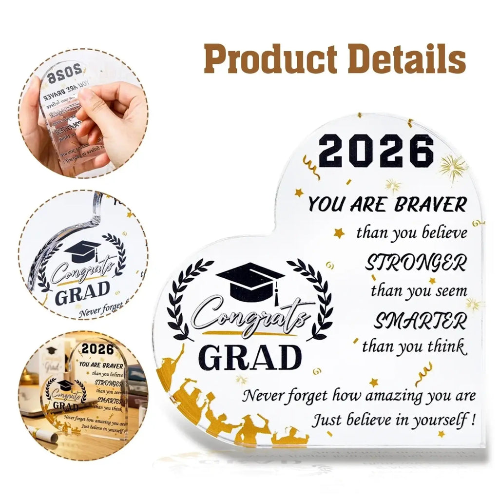 Clear acrylic heart-shaped class of 2026 graduation keepsake with black and gold engraved text and graduate cap emblem