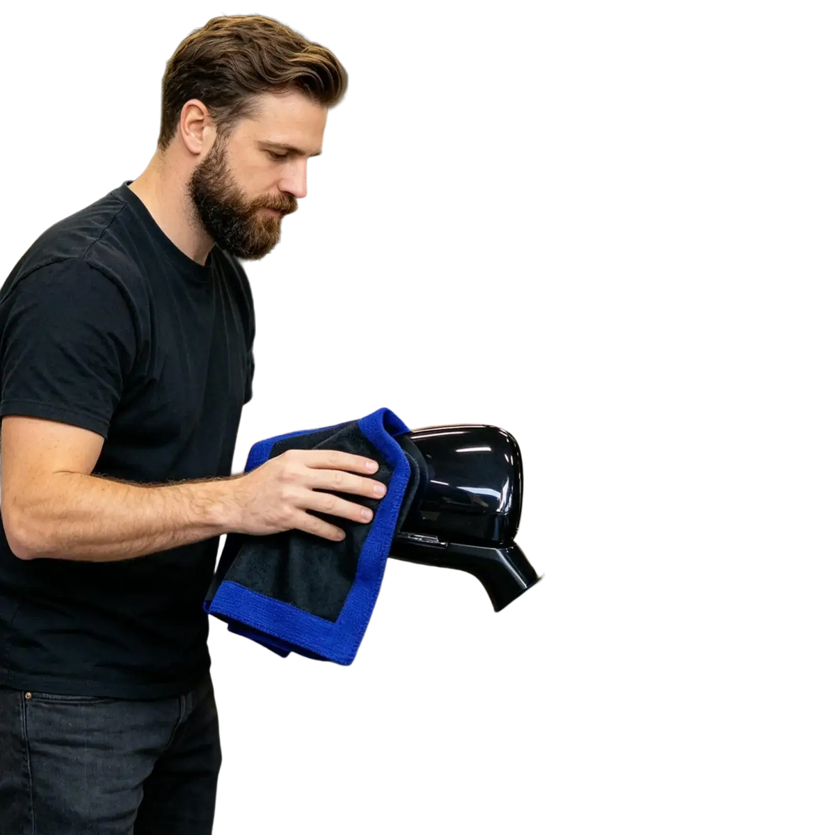 A man using a blue microfiber clay bar towel for car detailing and deep cleaning on a glossy black side mirror