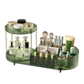 Green translucent two-tier clear acrylic rotating makeup organizer tray with gold-tone metal legs and dividers