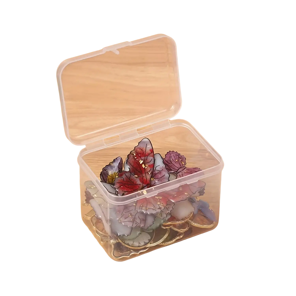 Clear plastic storage box filled with colorful glass butterfly decorations for crafts and rhinestones organization