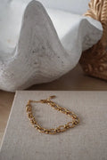 Cleo gold interlocking oval link chain bracelet in gold tone with classic link design and polished finish