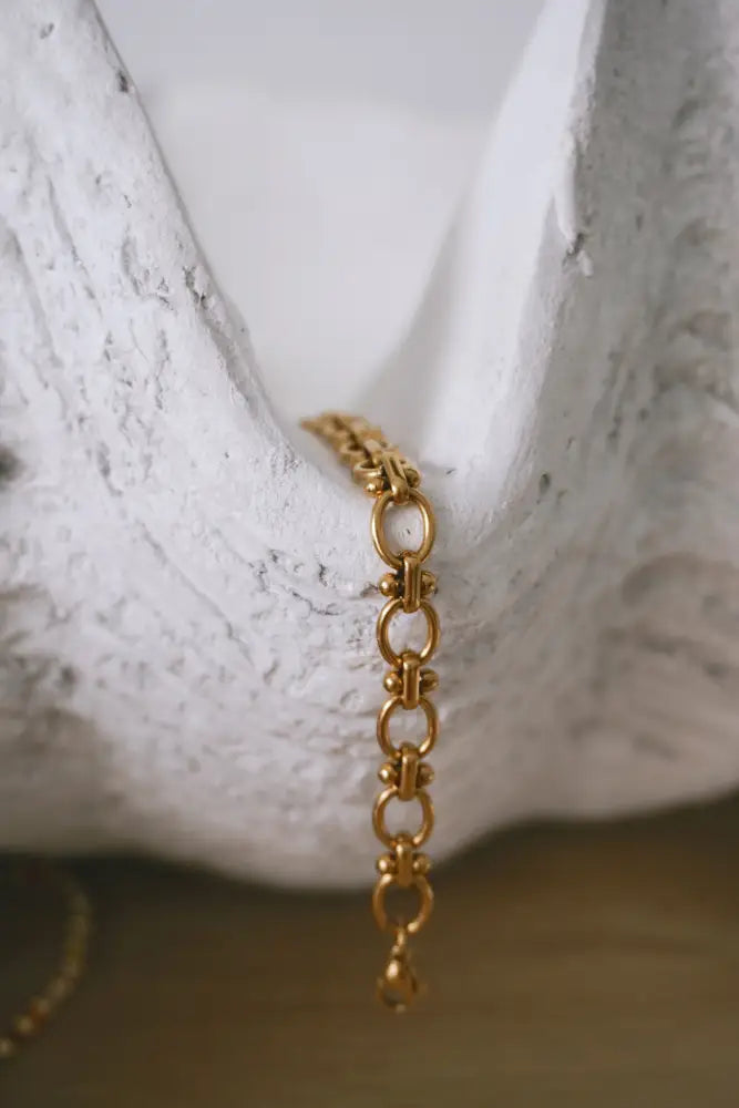 Cleo gold interlocking oval link chain bracelet featuring a gold-toned classic oval link design