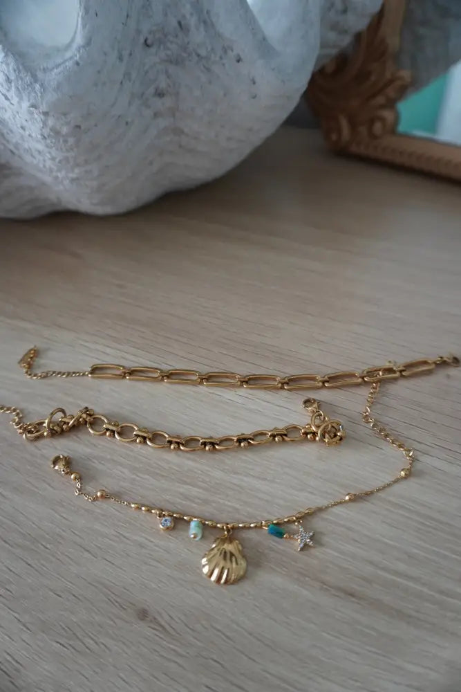Cleo gold interlocking oval link chain bracelet set with chunky link chain and layered beaded anklets with seashell charm