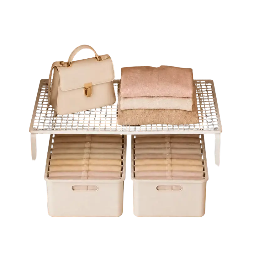 Cream-colored handbag with gold-tone clasp and handles resting on metal wire closet shelf expandable cabinet organizer