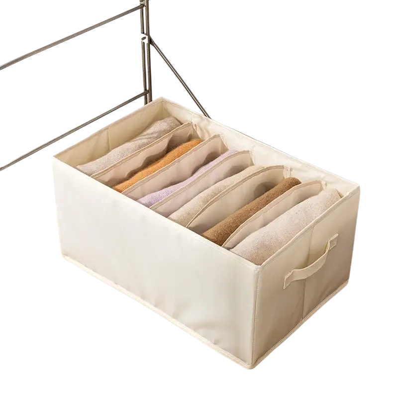 Beige fabric clothes storage box with six compartments for organizing folded clothing and jeans in wardrobe storage