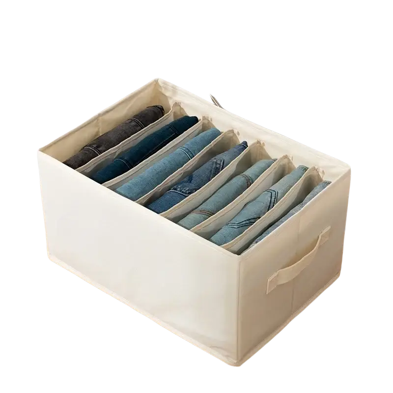 Cream-colored fabric clothes storage box with seven compartments neatly holding blue jeans for wardrobe storage