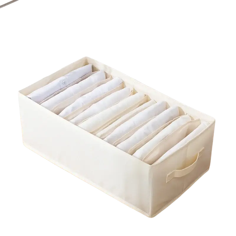 Cream-colored fabric clothes storage box with ten compartments for neatly storing folded clothing items and jeans