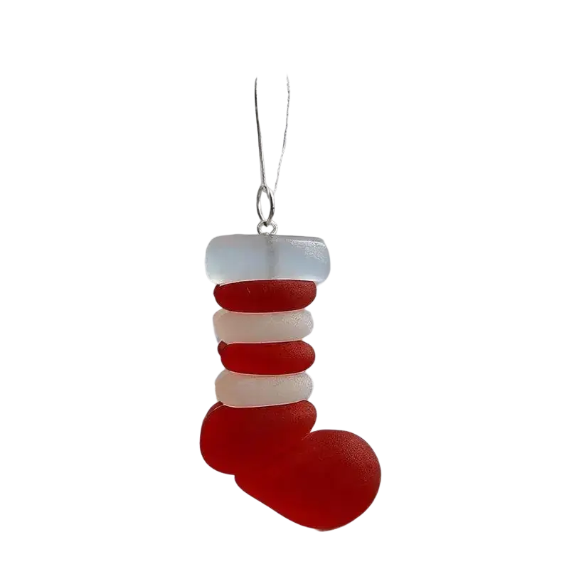 Red and white striped glass christmas ornament stocking hanging on tree for christmas coastal decor