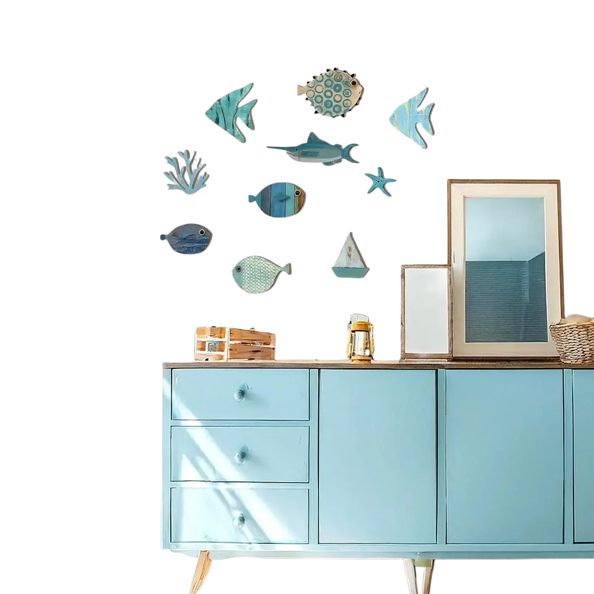 Blue painted wooden cabinet with three drawers and coastal style art fish shaped wall decor in blue and teal shades