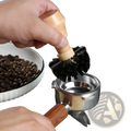 Wooden-handled coffee machine cleaning brush with dense black bristles designed for effective coffee equipment cleaning