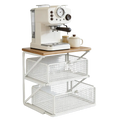 Cream-colored espresso machine with black handle and silver accents on white metal wire coffee station organizer with counter shelf