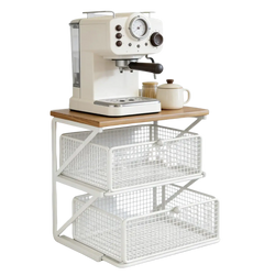Cream-colored espresso machine with black handle and silver accents on white metal wire coffee station organizer with counter shelf
