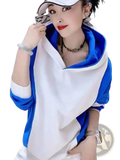 Blue and white color block hooded sweatshirt with contrasting blue inner lining made from loose cotton pullover material