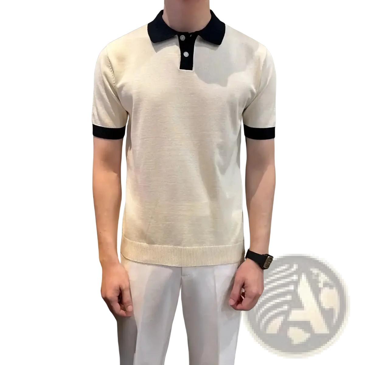 Cream-colored color block knit polo shirt with black collar and sleeve cuffs made from soft knit fabric