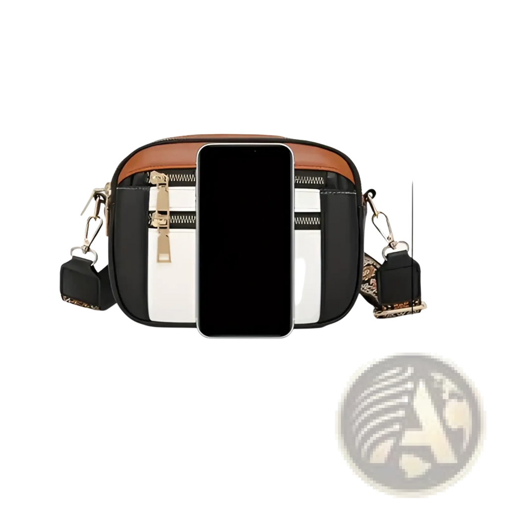 Colorblock leather crossbody bag in black and white with brown trim gold zippers and detachable floral strap