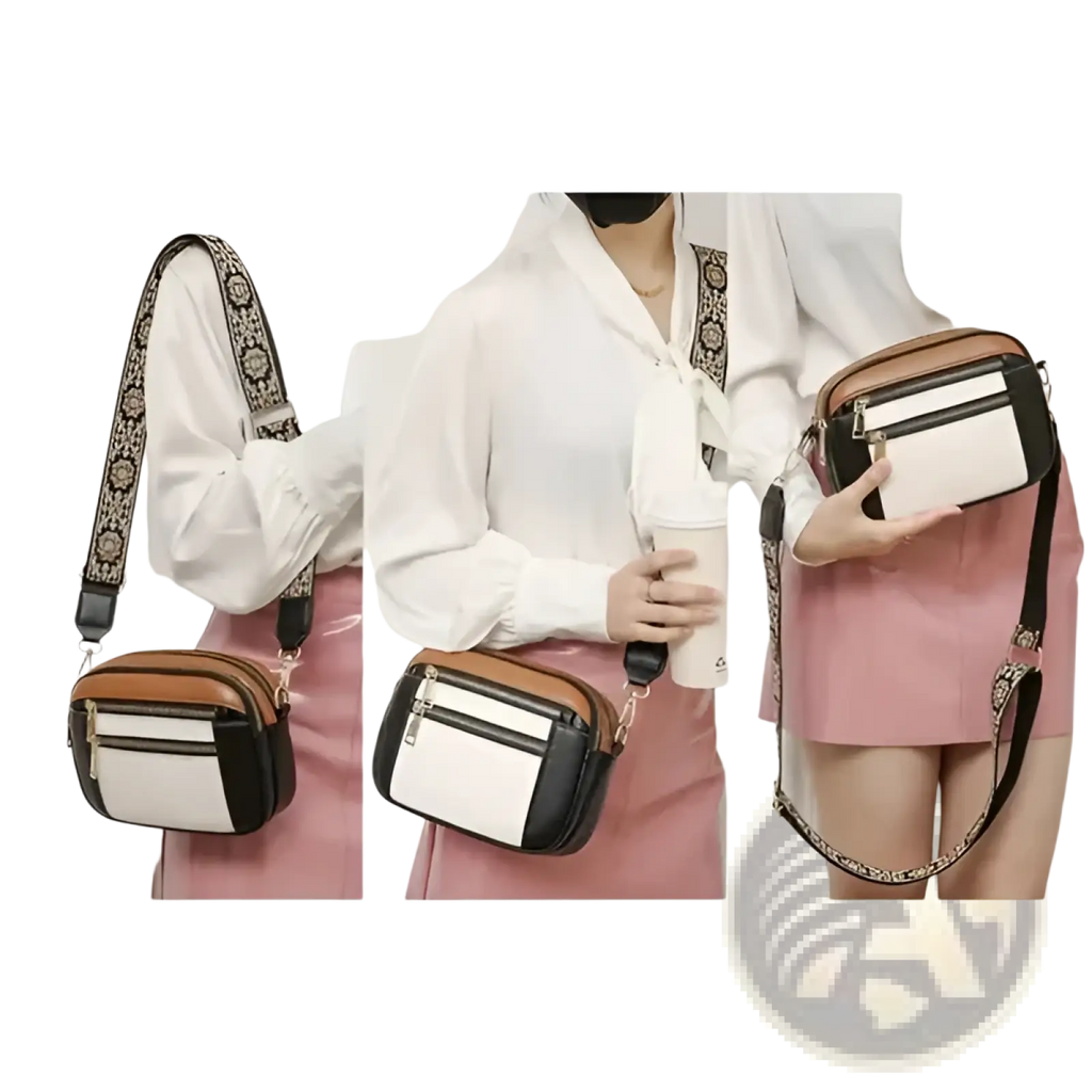 A stylish colorblock leather crossbody bag in white black and tan with a floral patterned strap