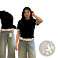 Colorblock ruffled short sleeve knit top in black with white ruffled trim at hem and sleeves in short-sleeved design