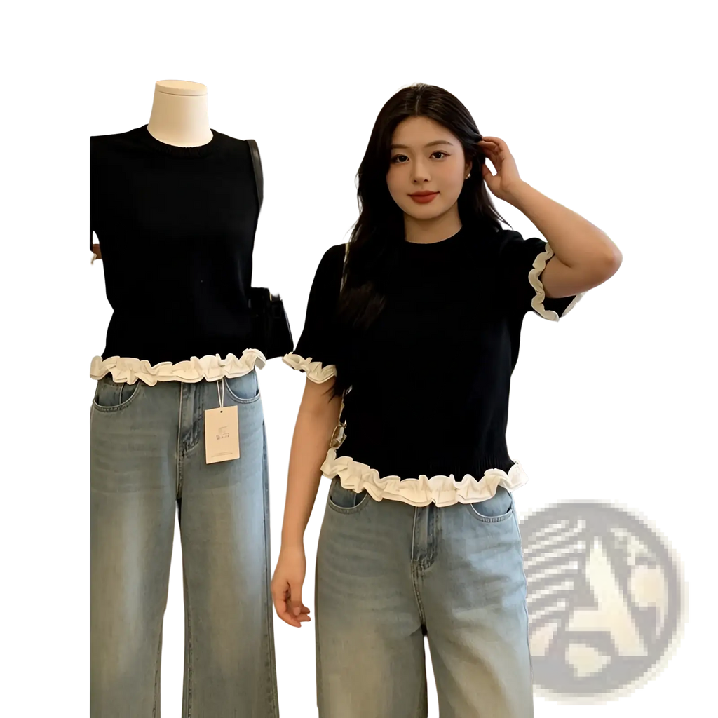 Black short-sleeved knit top with white ruffled trim at hem and cuffs colorblock ruffled short sleeve knit top