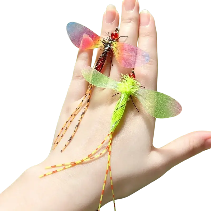 Two colorful translucent insect-shaped dragonfly cat toy replacement heads in pink to blue and glowing lime green rest on a palm