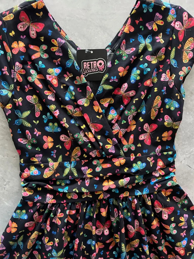 Greta colorful butterfly print cotton v neck dress in black with vibrant pink orange blue and green butterfly pattern