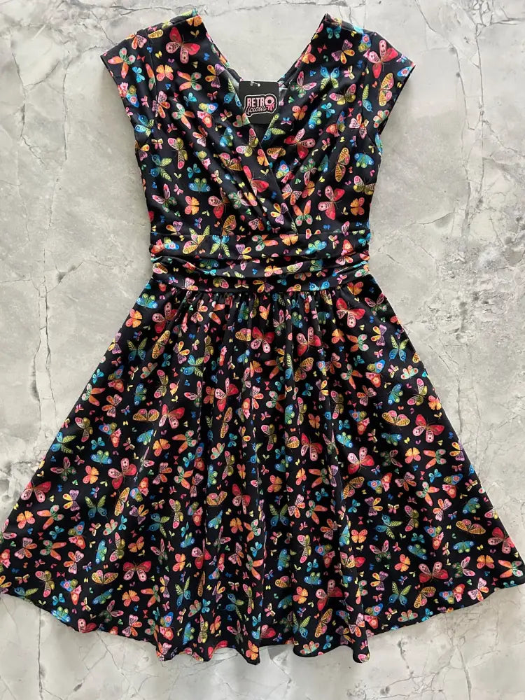 A black cotton greta colorful butterfly print dress with short sleeves and fitted waist in vibrant multicolored butterflies