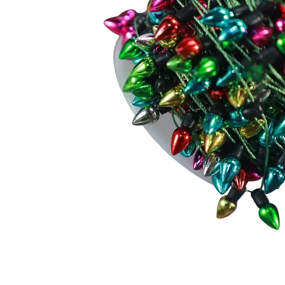 A bundle of metallic colorful christmas garland string lights in vibrant red green gold teal and pink hues