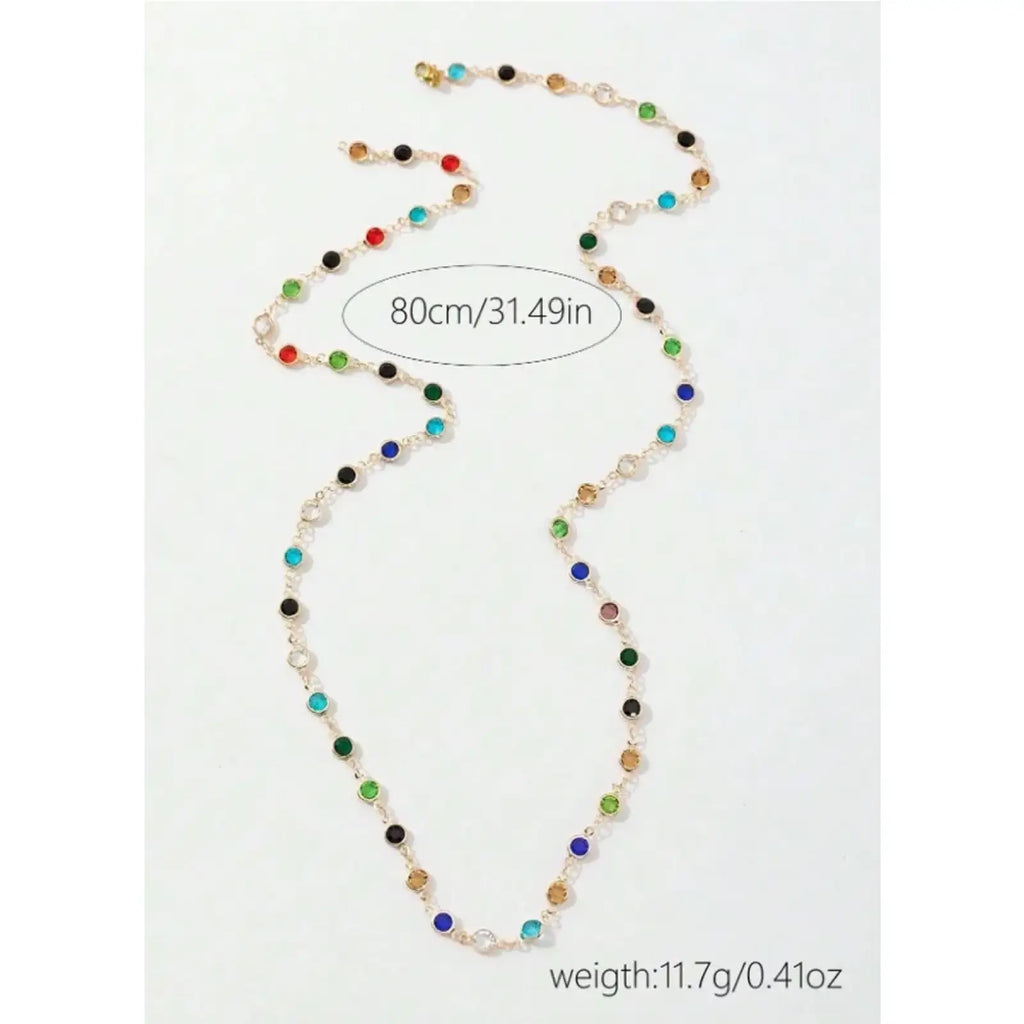 Colorful crystal tassel statement necklace featuring a gold-toned chain with red green blue black and clear stones