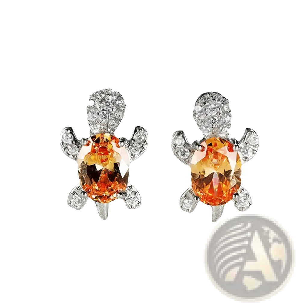 A pair of colorful crystal turtle stud earrings with orange gemstone centers and diamond accents on shell and flippers