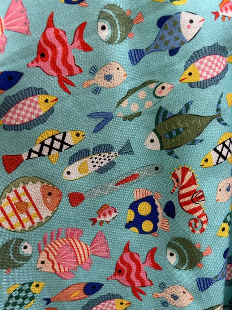 Teal colorful fish print vintage a line skater skirt in vibrant turquoise fabric with playful multicolored cartoon fish pattern