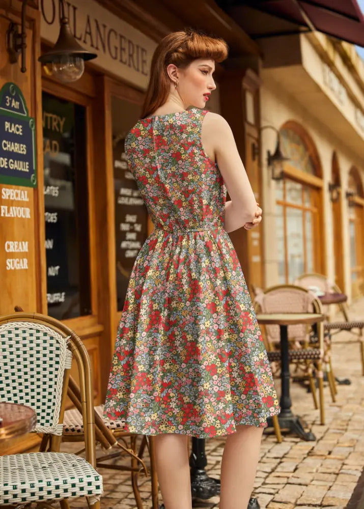 Vintage 1950s painted floral cotton a-line dress with pockets in soft pastel tones featuring red green and yellow blossoms