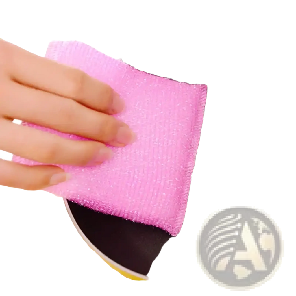 Pink abrasive kitchen sponge scrubber cleaning a black non-stick frying pan from colorful kitchen sponge 4 pack
