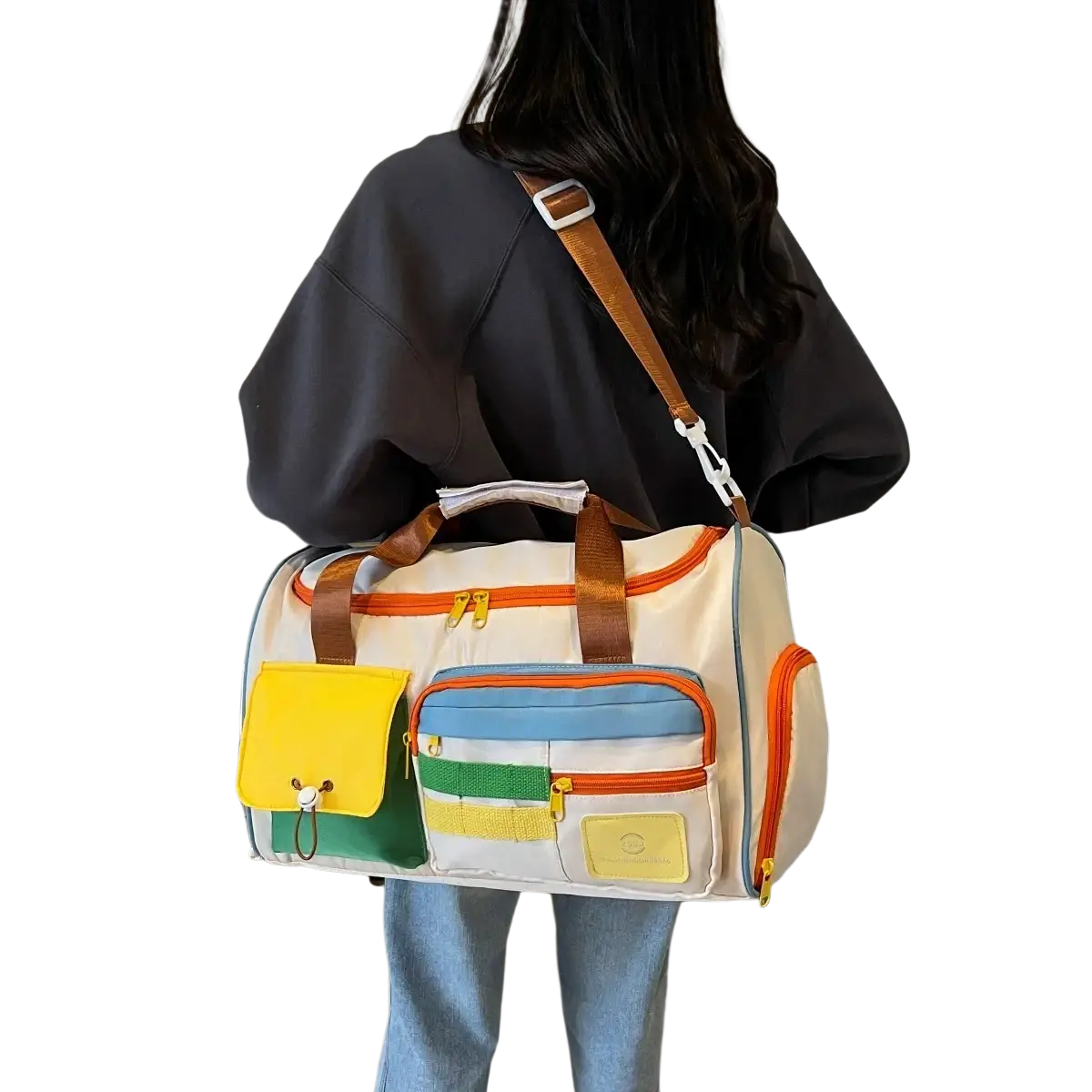 Colorful multi pocket travel duffel bag with cream base and vibrant orange yellow green and blue accents