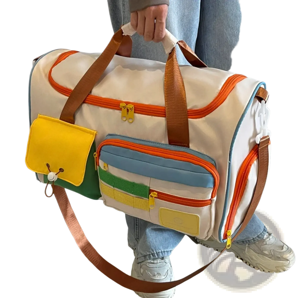 Colorful multi pocket travel duffel bag with white base orange zipper trims and brown leather handles and straps