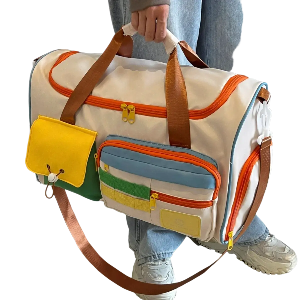Colorful multi pocket travel duffel bag with white base orange zipper trims and brown leather handles and straps