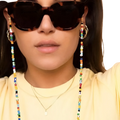 Tortoiseshell sunglasses with colorful rainbow beaded eyeglass and mask lanyard chain attached to the temples