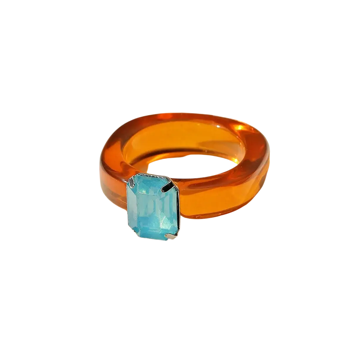 A colorful resin crystal geometric ring for women with a vibrant orange translucent band and blue emerald-cut stone set in silver metal