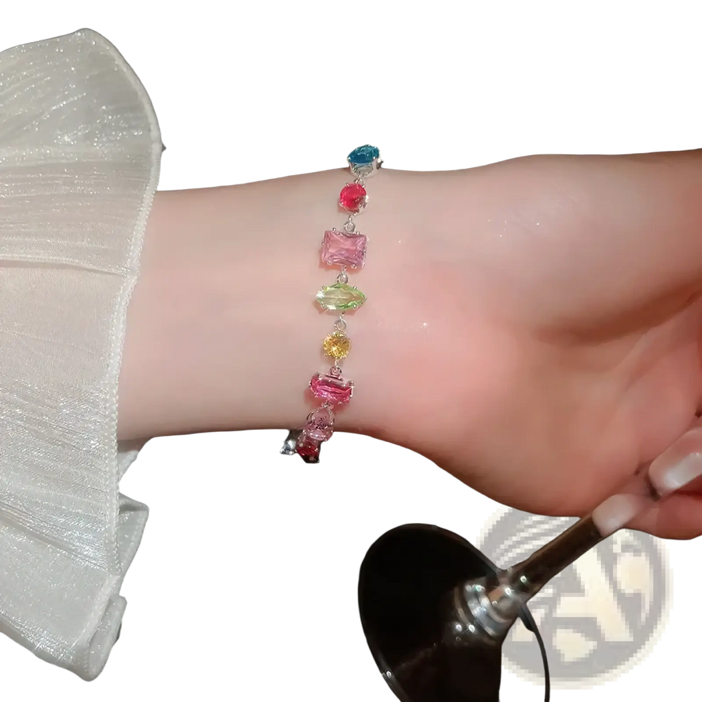 A delicate silver bracelet adorned with colorful faceted gemstones complements the colorful zircon crystal gold plated necklace
