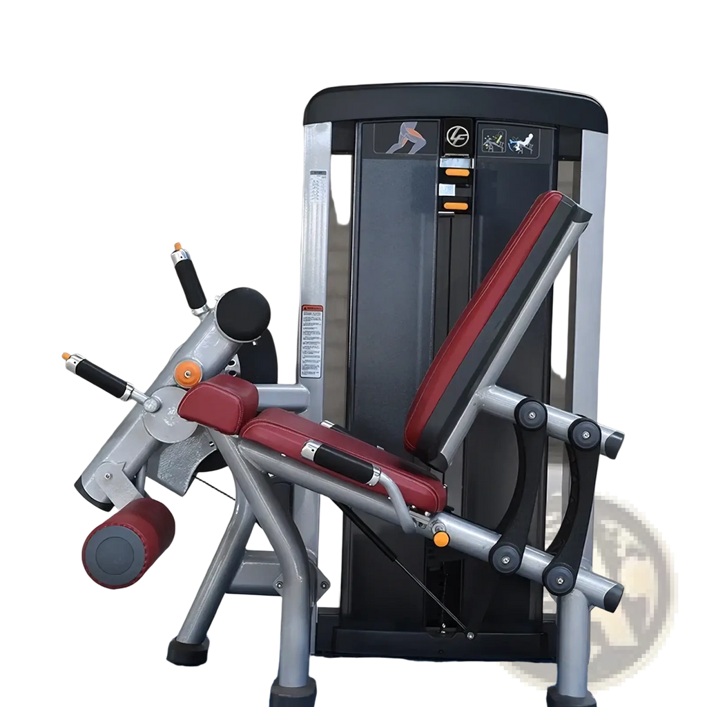 Commercial strength training leg extension machine with red and black padded seat and silver metal frame for gym use