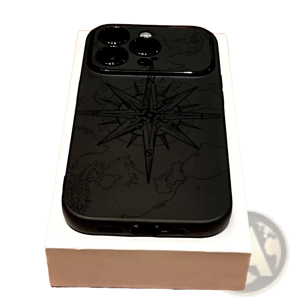 Back side of a black shockproof matte iphone case with an engraved compass rose over a world map design