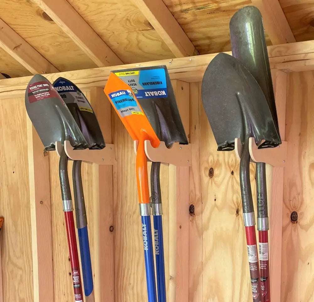 Set of four kobalt shovels with black metal blades and colorful fiberglass handles in a stud mounted garden tool wall organizer kit