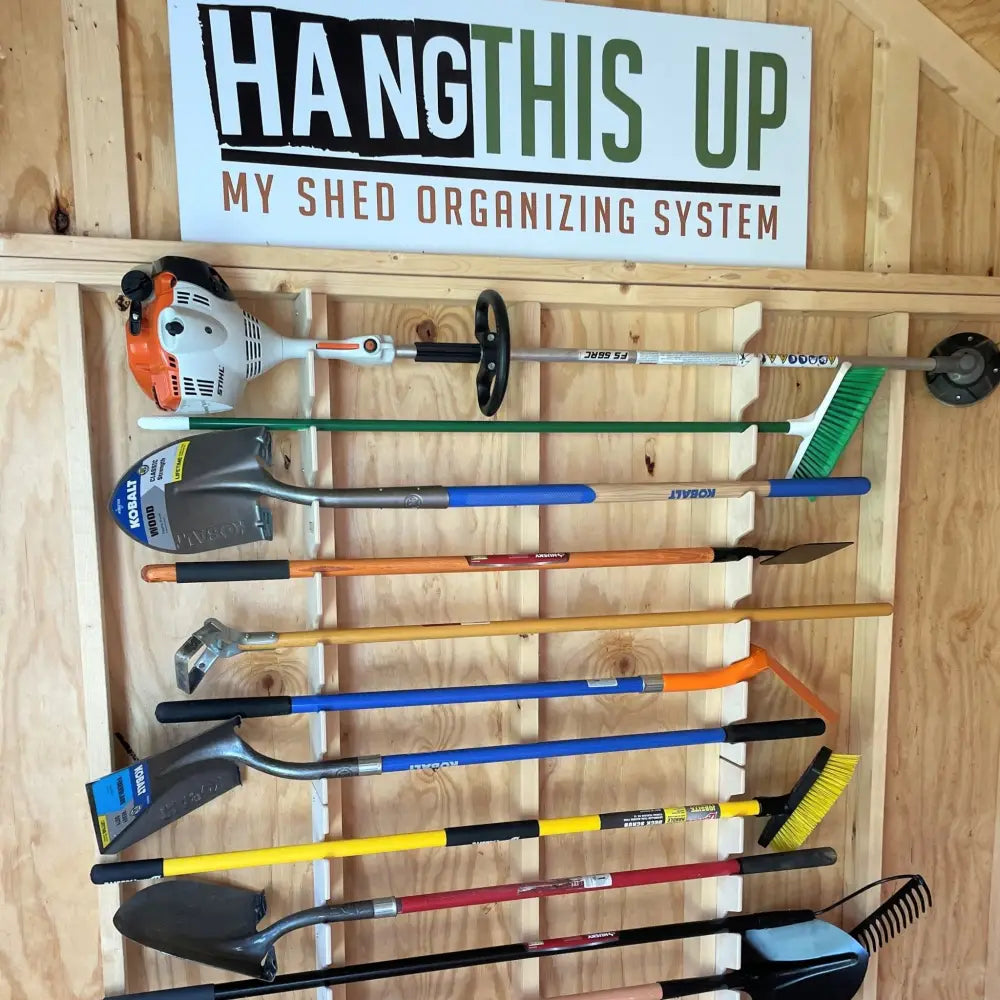 Collection of colorful garden tools with black grips neatly arranged on a stud mounted wooden wall organizer kit