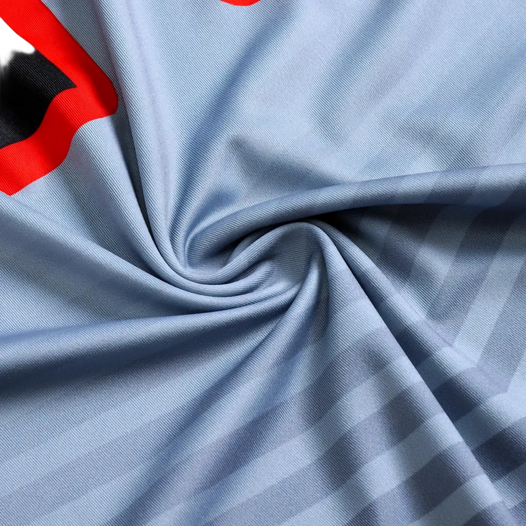 Light blue long sleeve compression basketball shirt with subtle diagonal stripes and bold red and black dragon logo